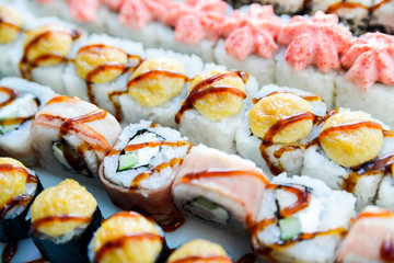 Set of rolls drenched with unagi sauce close-up.