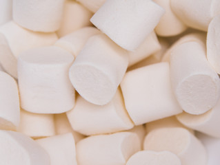 Fototapeta na wymiar White marshmallow close-up. Marshmallows for frying on the fire.
