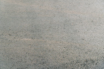 Seamless tarmac dark grey grainy road. Texture background