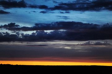 Obraz na płótnie Canvas Landscape with dramatic sky at sunset.