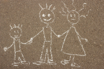 Children's chalk drawing happy family on the asphalt