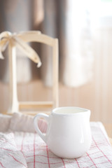 white a milk cup on the table