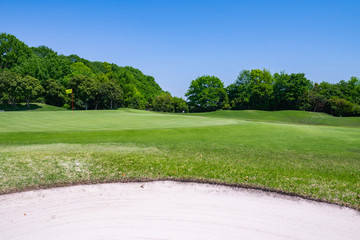 View of Golf Course with beautiful putting green. Golf course with a rich green turf beautiful scenery.