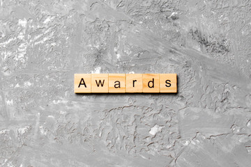 AWARDS word written on wood block. AWARDS text on cement table for your desing, concept
