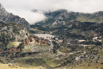 A white village called Grazalema between mountains and clouds.