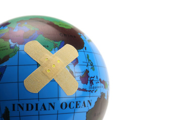 Globe with a bandage, plaster isolated on white. Concept of environmental and social issues human
