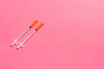 Top view of insulin syringes ready for injection on colorful background. Diabetic concept with copy space
