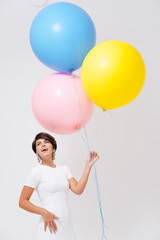 Fototapeta na wymiar portrait laughing woman with bunch of colorful balloons 