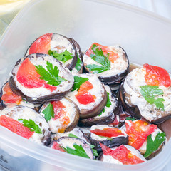 Fried eggplant in mayonnaise with garlic and pieces of red fish