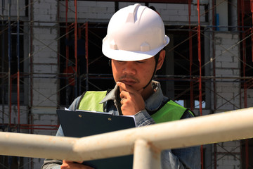 Construction workers holding boards to write work