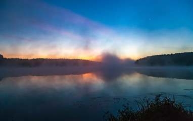 Mist over the lake dawn early morning in the summer