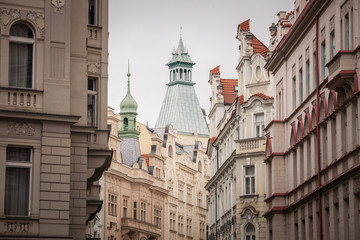 Typical Austro-Hungarian Facade of a baroque apartment residential building in a street of old town, the historical center of Prague, Czech Republic, in the most touristic part of the city.