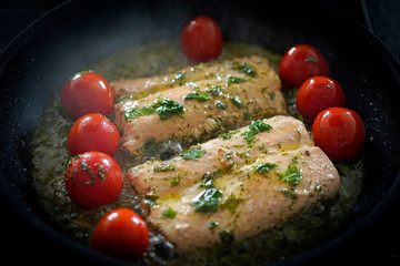 ready to eat - roasted salmon fish with cherry tomatoes and herbs in olive oil