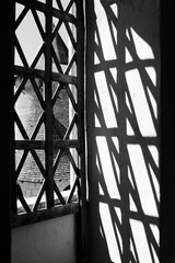 Shadows in the glass window. Old window in the castle.