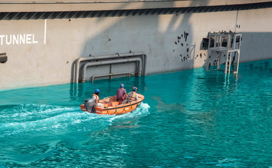 Rescue service swims quickly on a boat on the lake, safety lifeboat in the sea dry dock.