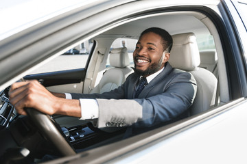Fototapeta na wymiar Joyful Man Driving Car Sitting Holding Steering Wheel
