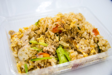Fried rice in a box placed on a white background.