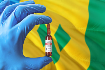 Saint Vincent And The Grenadines flag with Coronavirus Covid-19 concept. Doctor with blue...