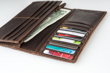 Brown leather wallet with credit cards and money