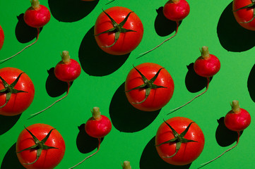 Red juicy tomato on a green background.

