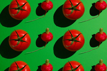 Red juicy tomato on a green background.
