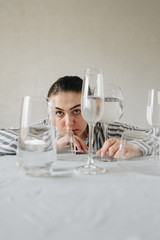 beautiful girl with glasses of water on the table