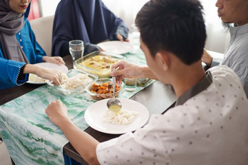 portrait close up of hand family muslim eating in dinning table together