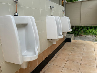 Men's white urinals design, Close up row of outdoor urinals men public toilet, Urinal concept.
