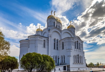 Orthodox Church against the blue sky with clouds in summer