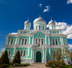 Fototapeta na wymiar Orthodox Church against the blue sky with clouds in summer
