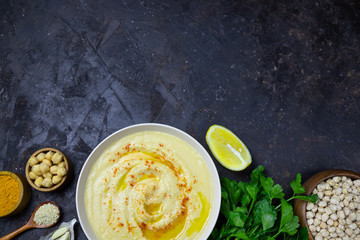 Obraz na płótnie Canvas chickpeas hummus with olive oil on a black background