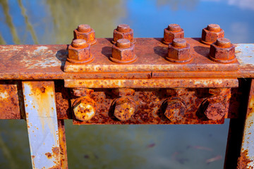 Joint of steel construction on the bridge, rusty screws