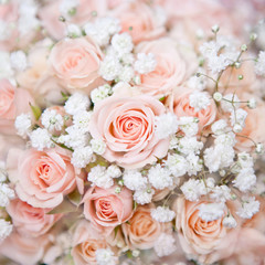 soft pink wedding bouquet with rose bush and little white flowers