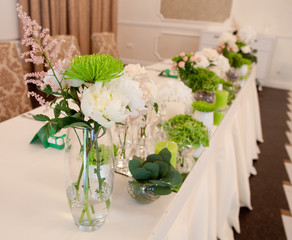 interior decorated in green by using fresh flowers and candles