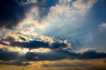 Fototapeta na wymiar Rays on the blue sky with cumulus clouds
