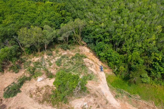Aerial view of deforestation of a tropical rainforest to make way for logging and palm oil plantations contributing to climate change and global warming