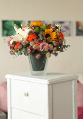 floral bouquet with lily, sunflower, chrysanthemum, eustoma (lisianthus) astrantsiya, eucalyptus, shrub rose