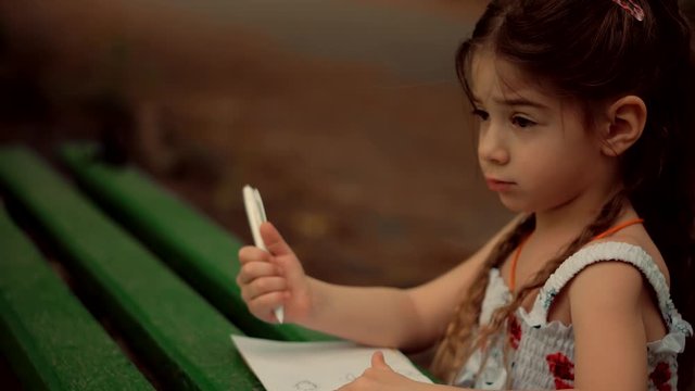 Little Girl Draws On Paper.	