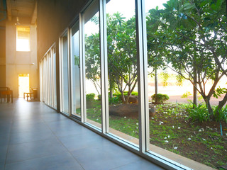 concrete polishing floor and green garden with sun light of modern office decoration.