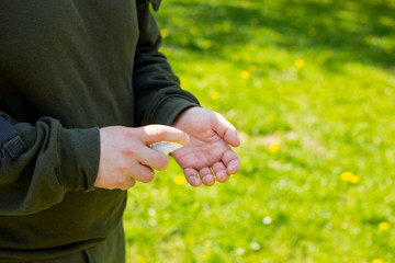 Man hands using wash hand sanitizer, against Novel coronavirus or Corona Virus Disease on a city public park bacground. Antiseptic, Hygiene and Healthcare concept