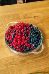 raspberries and blueberries in plate