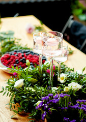 table decorated with candles and a wreath of flowers