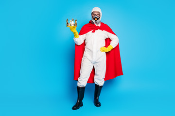 Best strength ncov disinfection service concept. Man doctor hold golden crown wear white suit yellow goggles latex gloves gas respirator red costume mantle isolated blue color background