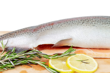 Whole Fresh potted red fish with slices of lemons and branches of rosemary on a wooden board. Vitamins and a healthy diet. Side view. Isolated on a white background. Space for text.