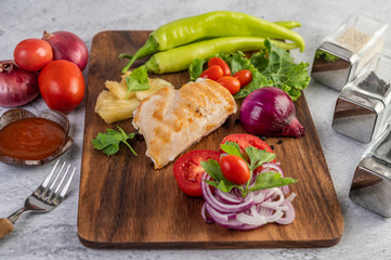 Chicken steak placed on a wooden tray.