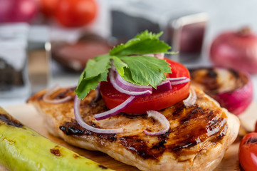 Chicken steak placed on a wooden tray.