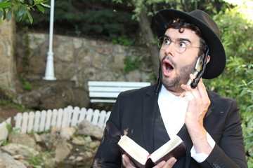 Jewish man getting shocking news on the phone
