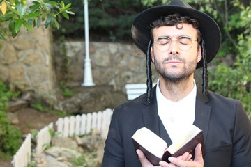 Man praying with eyes closed