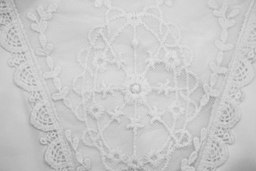 A background image of ivory-colored lace cloth. White lace on beige background.