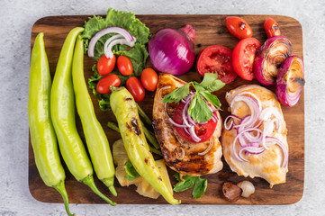 Chicken steak placed on a wooden tray.